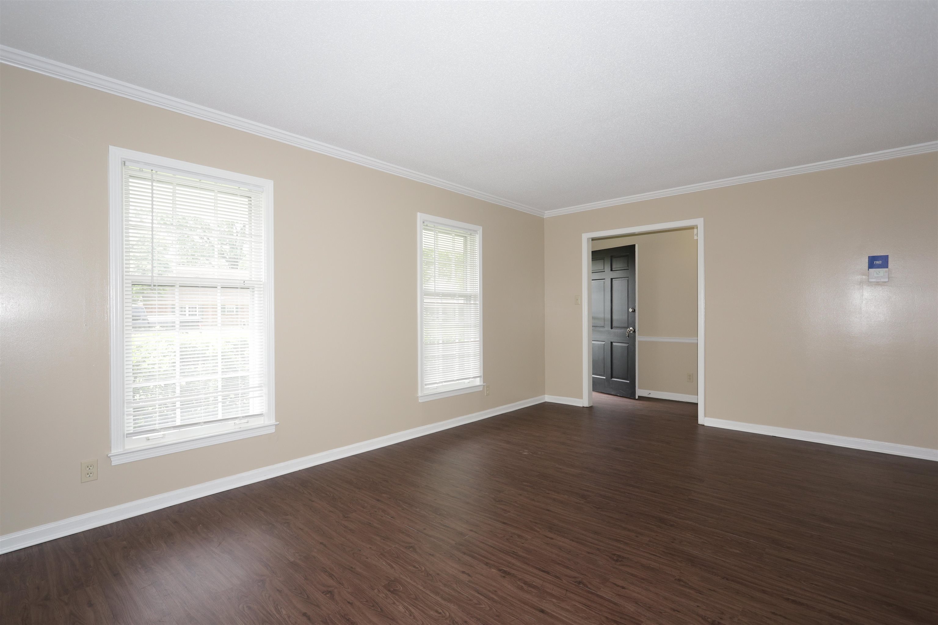 1812 Whitman Road Memphis, TN 38116 - Photo 6 of 18 an empty room with wooden floor and windows