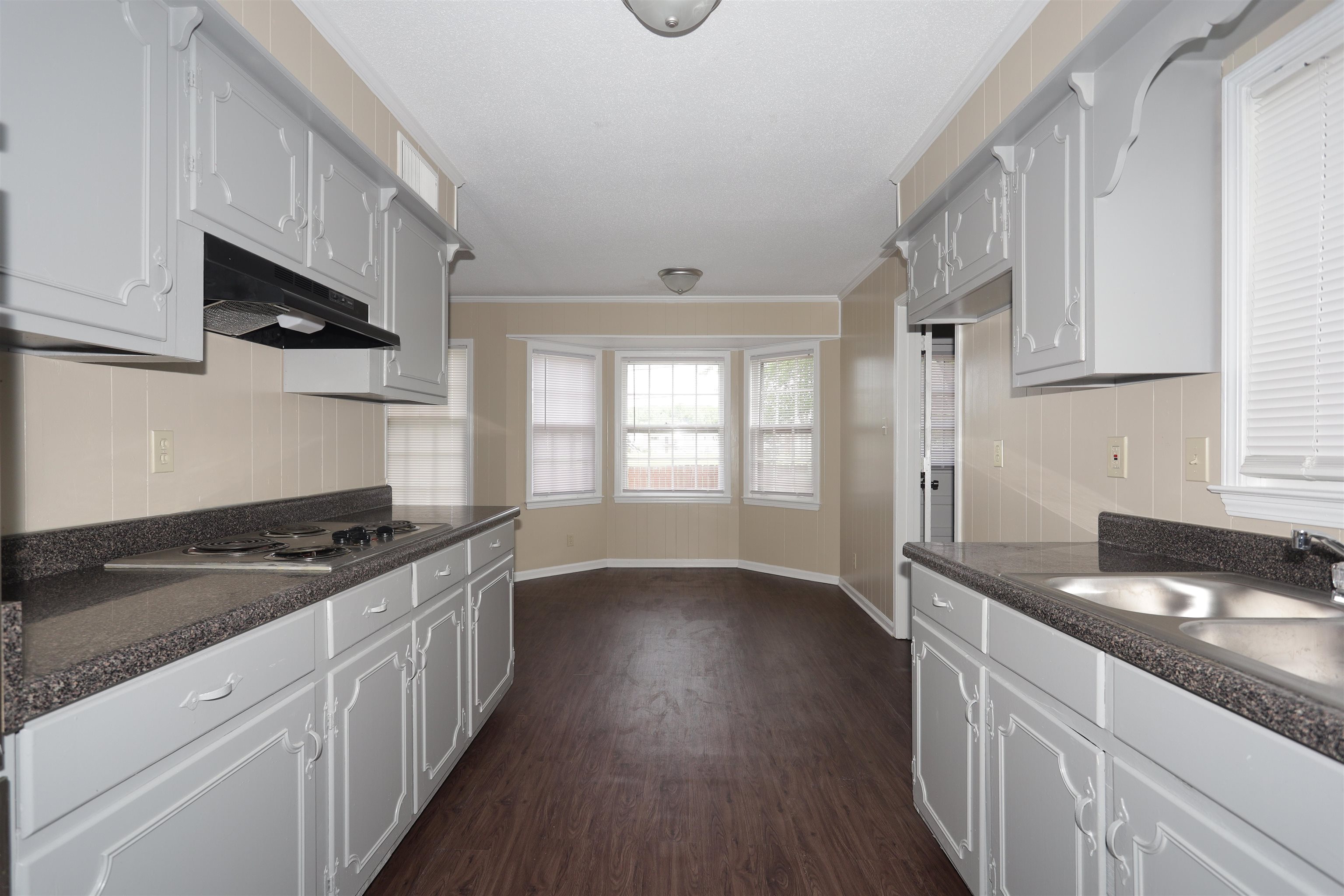 1812 Whitman Road Memphis, TN 38116 - Photo 7 of 18 a kitchen with granite countertop a sink and cabinets with wooden floor