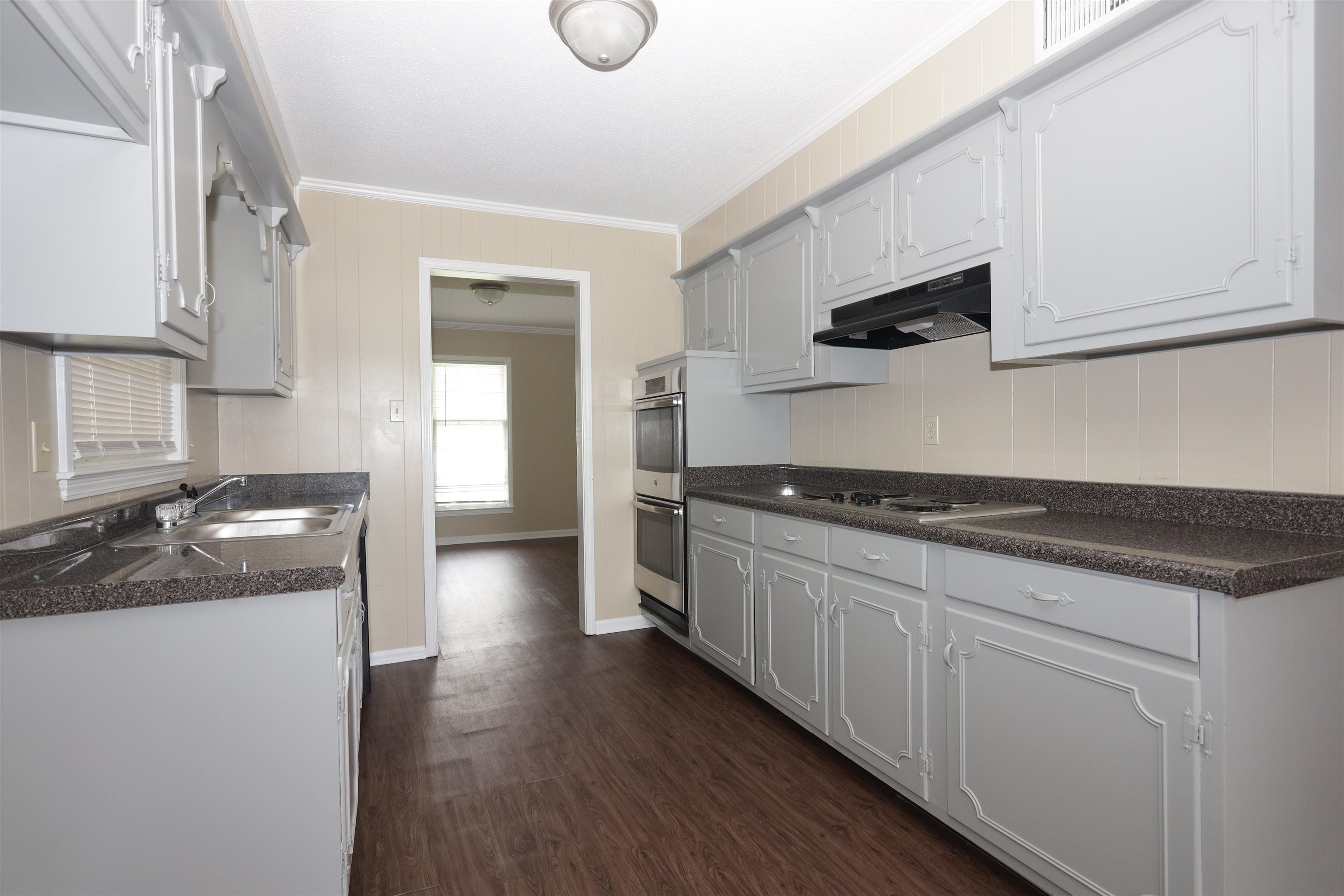 1812 Whitman Road Memphis, TN 38116 - Photo 9 of 18 a kitchen with stainless steel appliances granite countertop a sink and a stove top oven