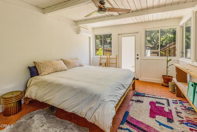 a bedroom with a bed and a painting on the wall