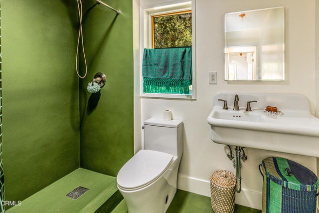 a bathroom with a sink mirror and toilet