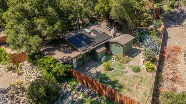 an aerial view of a house with a yard
