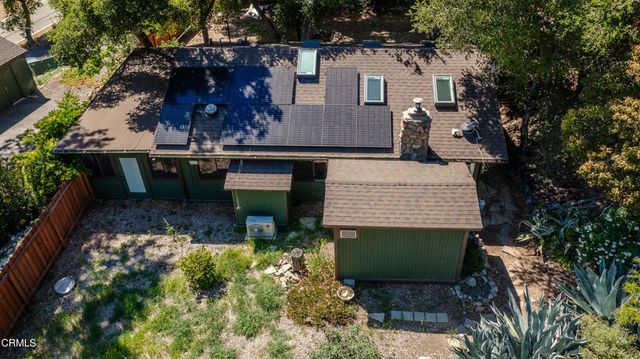 a view of a house with backyard and sitting area