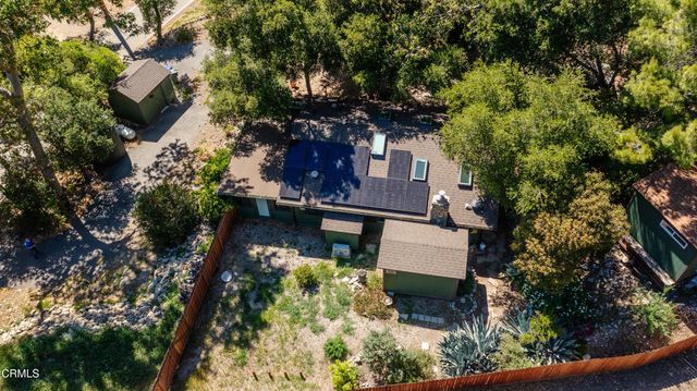 an aerial view of a house with a yard and garden