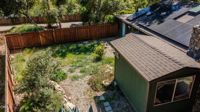 a view of a backyard with wooden fence
