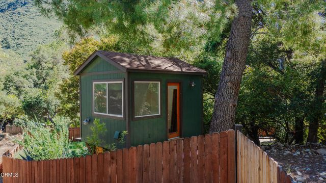 a view of a house with a tree beside it