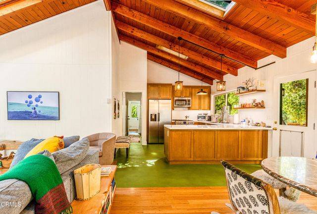 a living room with a table and chairs