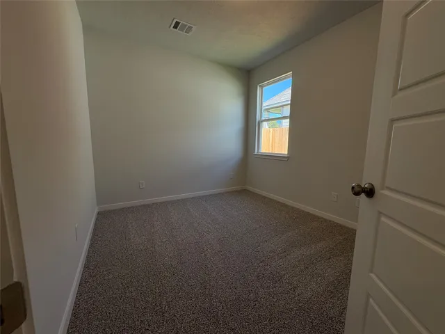 a view of empty room with windows