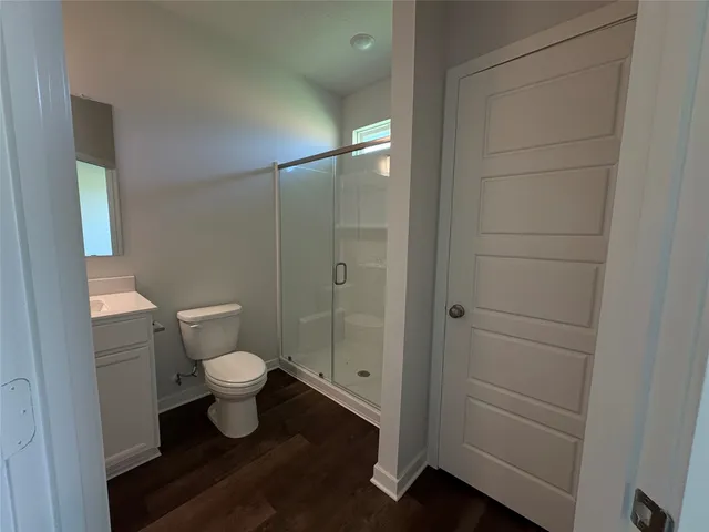 a bathroom with a toilet and a shower