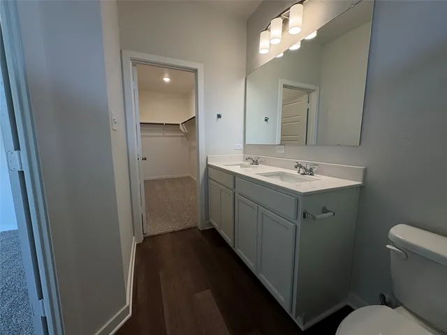 a bathroom with a sink toilet and mirror