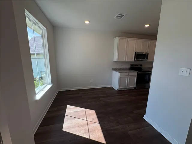 a kitchen with a sink a window and stainless steel appliances