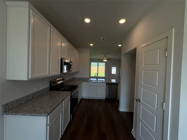 a kitchen with a sink and stove top oven