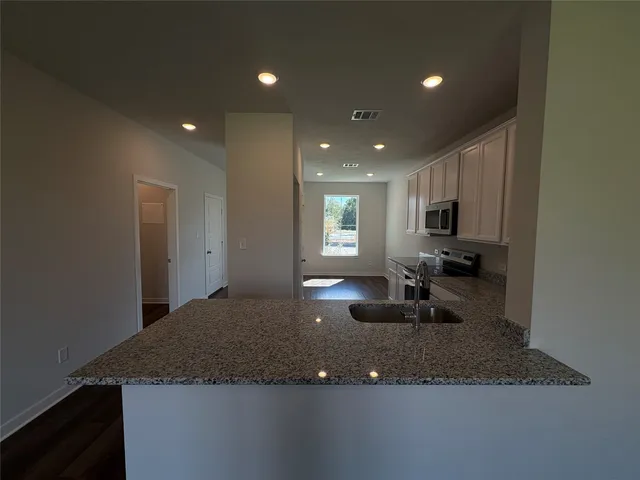 a view of a room with gym equipment and windows