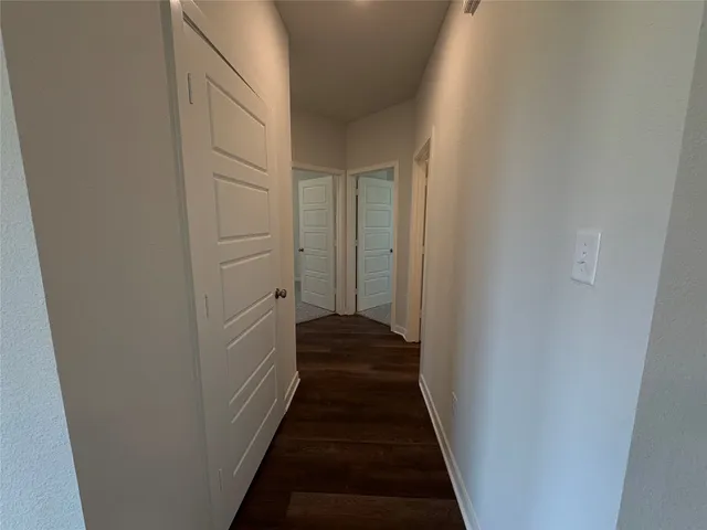 a view of a hallway with the wooden floor