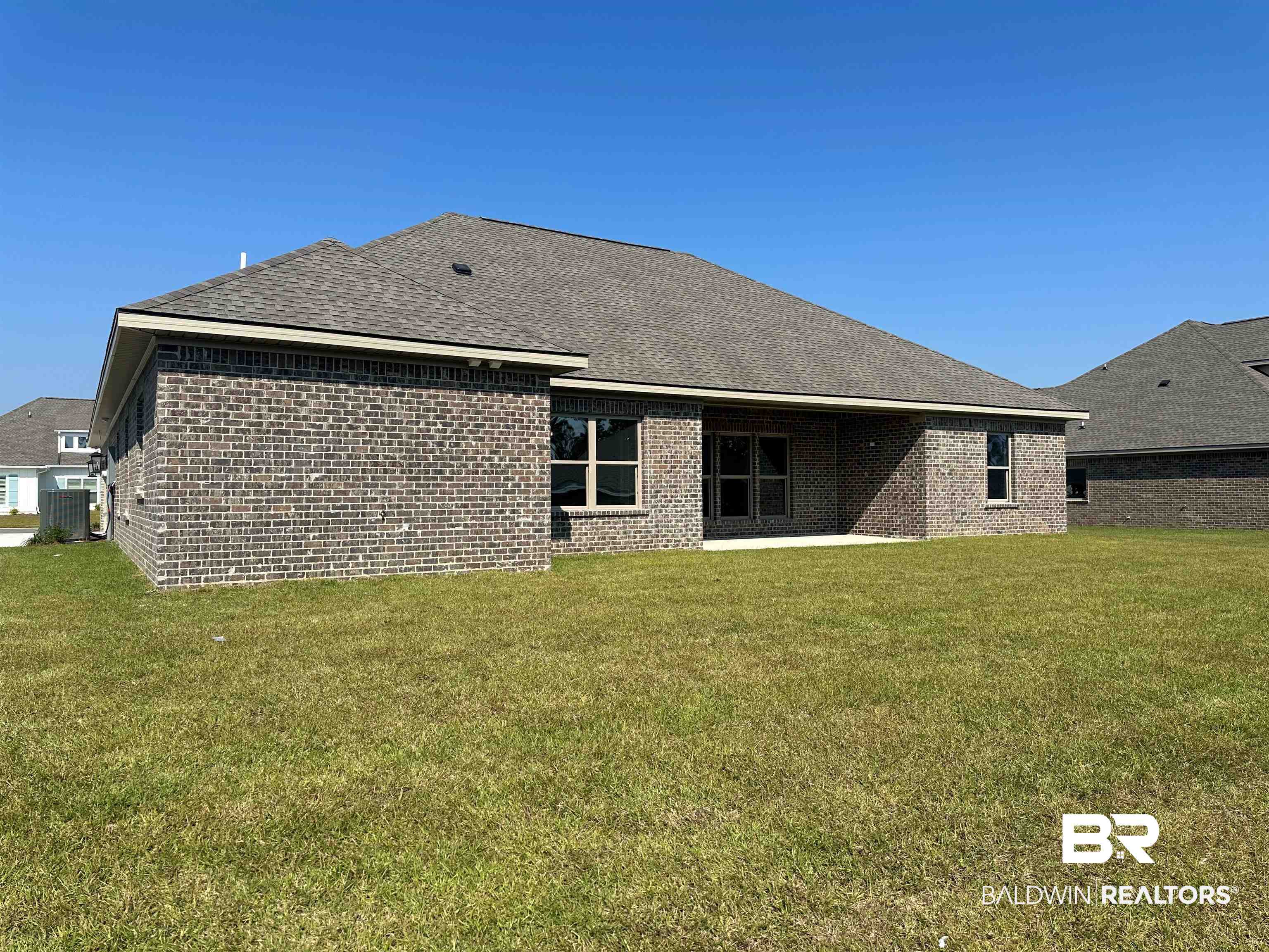 23548 Travis Stock Street, Unit 50 Foley, AL 36535 - Photo 6 of 30 Rear view of property featuring a lawn