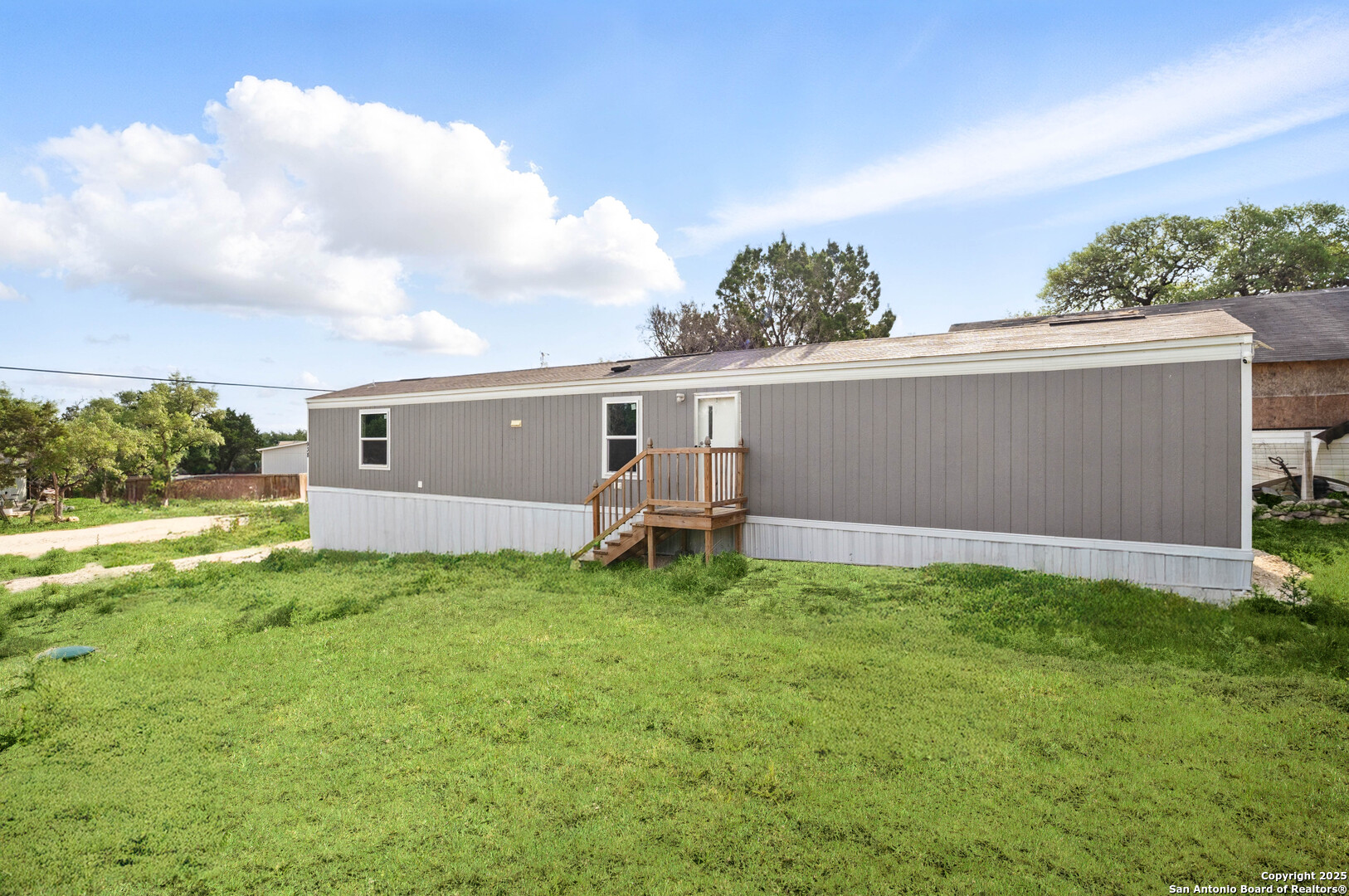 a backyard of a house with table and chairs
