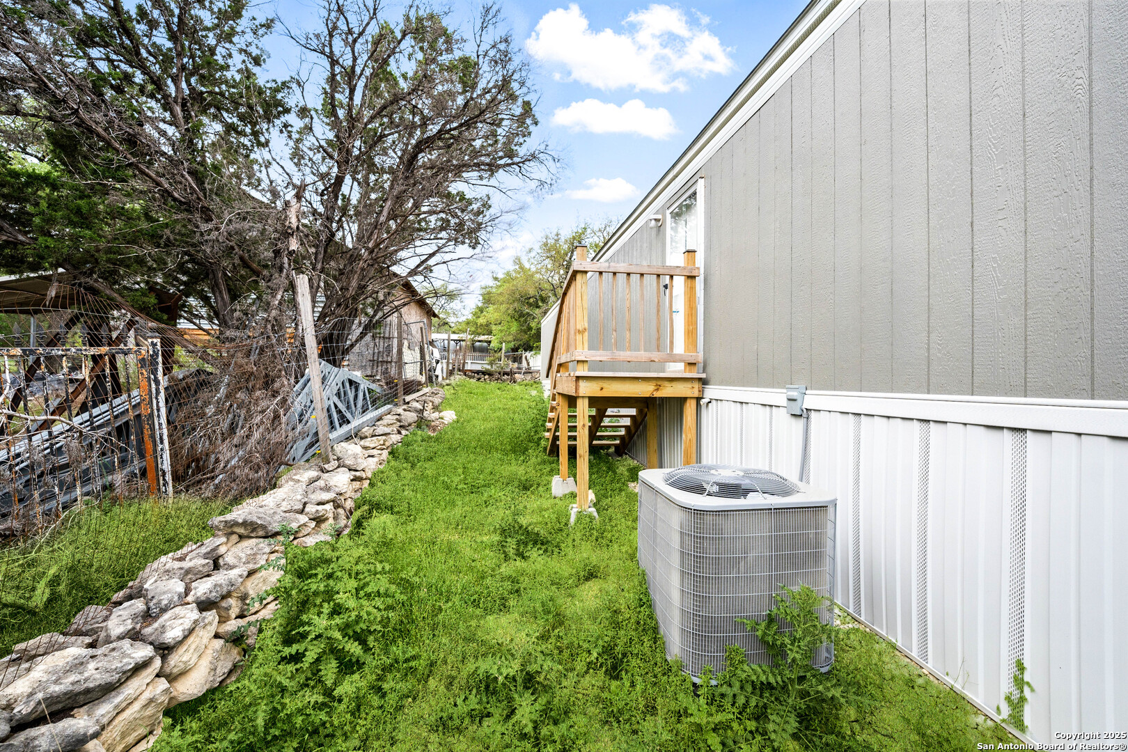 938 Covered Wagon Spring Branch, TX 78070 - Photo 19 of 20 a view of a chair and table in the backyard with wooden fence