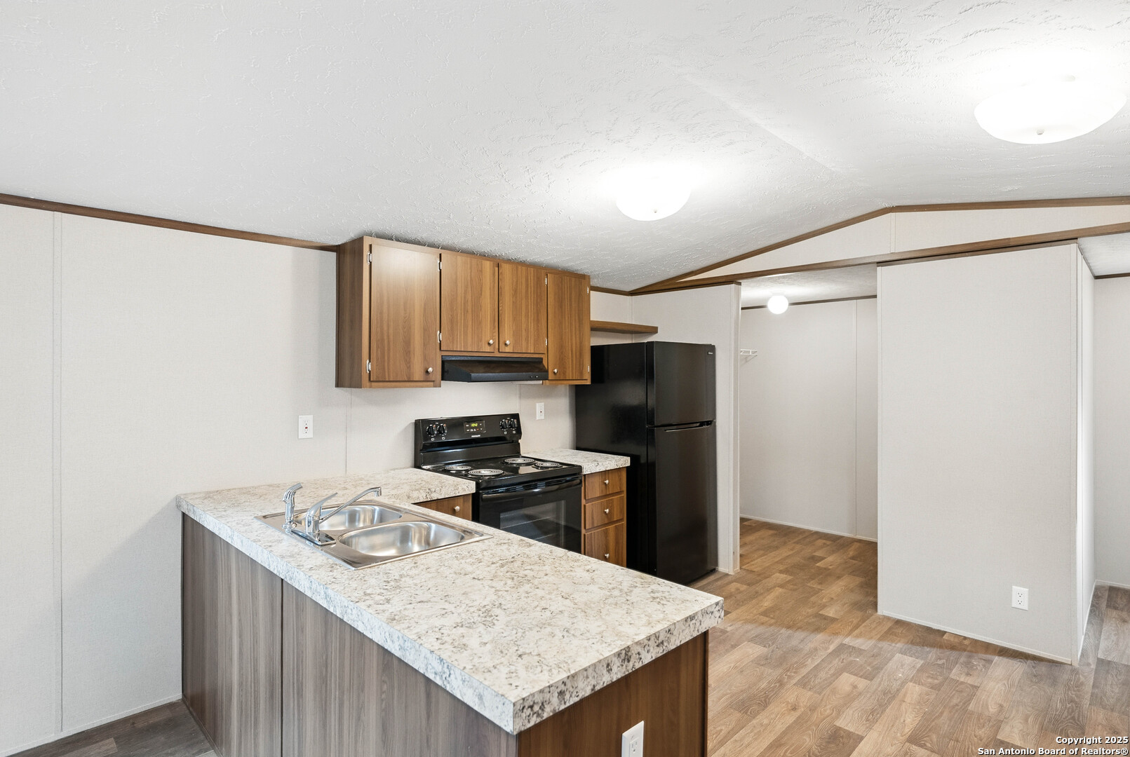 938 Covered Wagon Spring Branch, TX 78070 - Photo 3 of 20 a kitchen with a refrigerator a sink and a stove