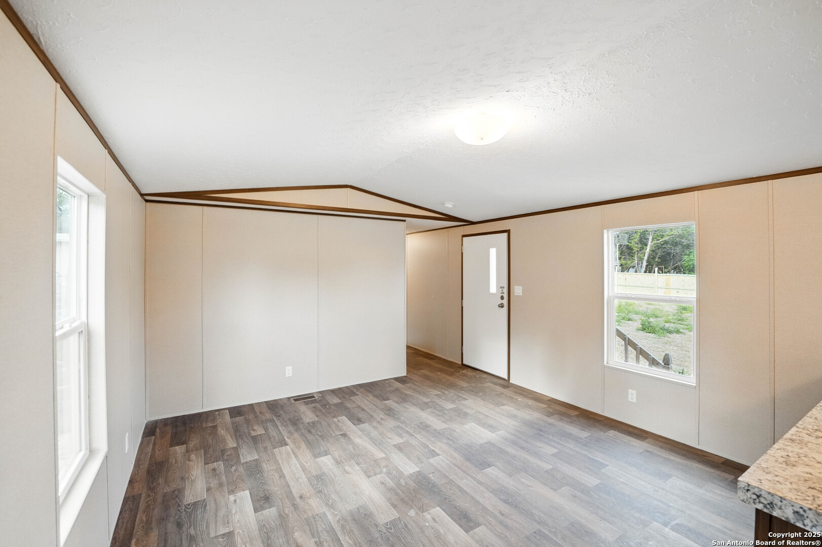 938 Covered Wagon Spring Branch, TX 78070 - Photo 8 of 20 an empty room with wooden floor and windows