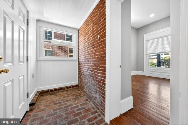 a view of a room with wooden floor and windows