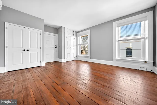 a view of a livingroom with wooden floor and window
