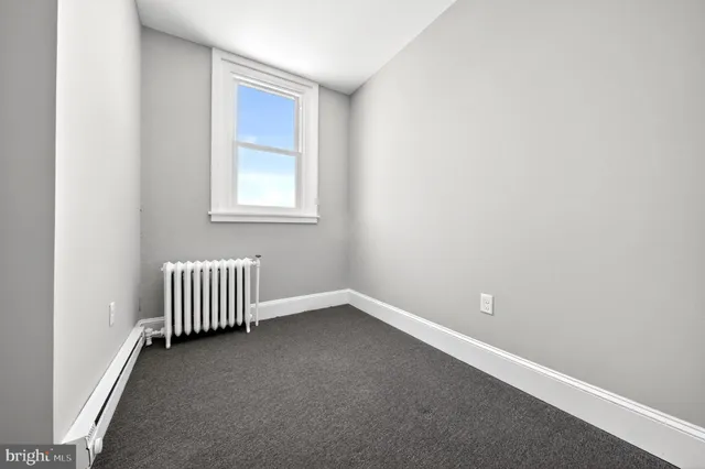 an empty room with floor to ceiling window