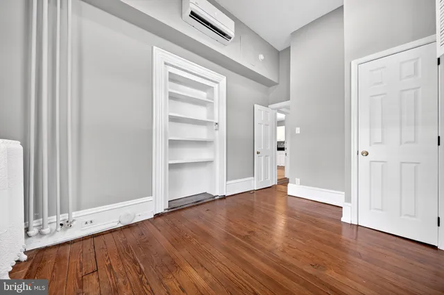 a view of an empty room with wooden floor