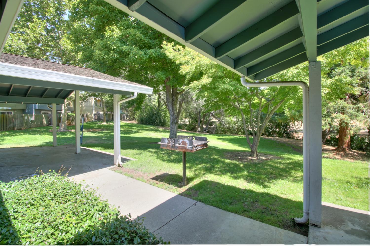 6114 Shadow Lane Citrus Heights, CA 95621 - Photo 26 of 56 a view of a chair and table in backyard under a large tree