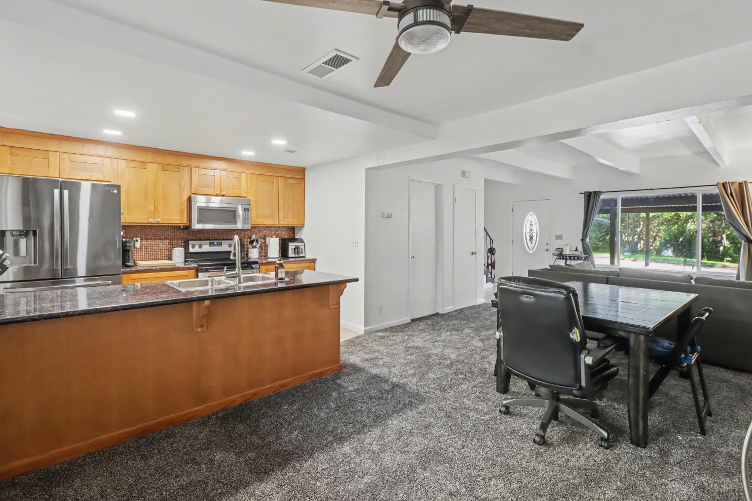 6114 Shadow Lane Citrus Heights, CA 95621 - Photo 39 of 56 a dining hall with stainless steel appliances granite countertop a sink a stove a dining table and chairs