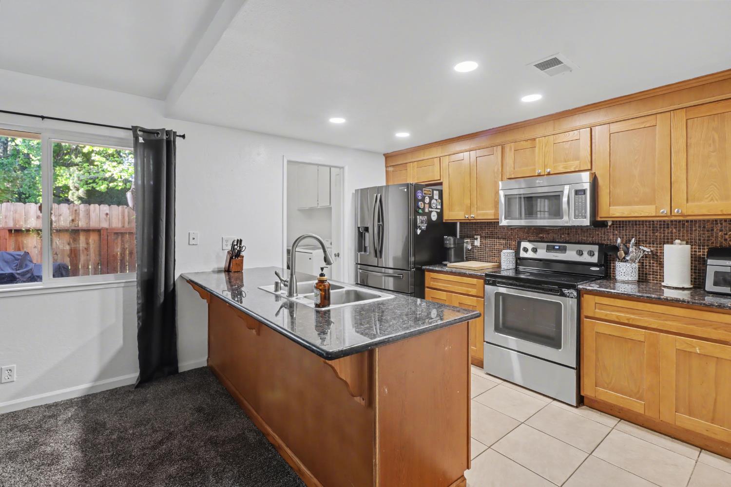 6114 Shadow Lane Citrus Heights, CA 95621 - Photo 41 of 56 a kitchen with stainless steel appliances granite countertop a sink stove and refrigerator