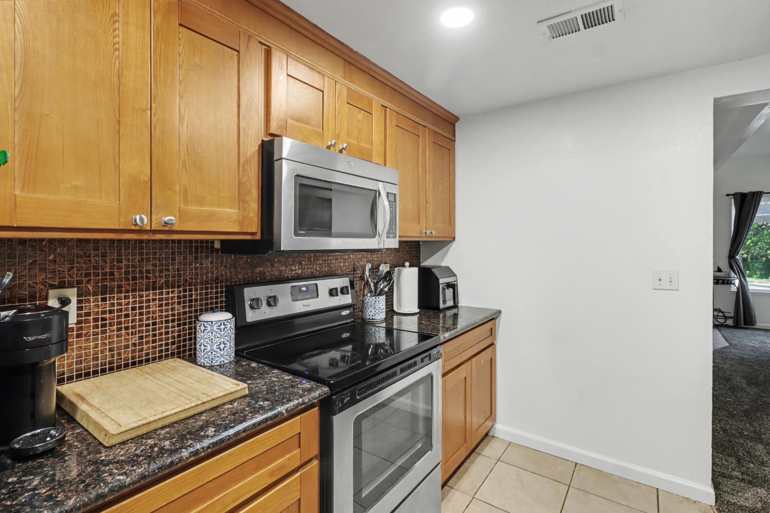 6114 Shadow Lane Citrus Heights, CA 95621 - Photo 43 of 56 a kitchen with a stove and a microwave