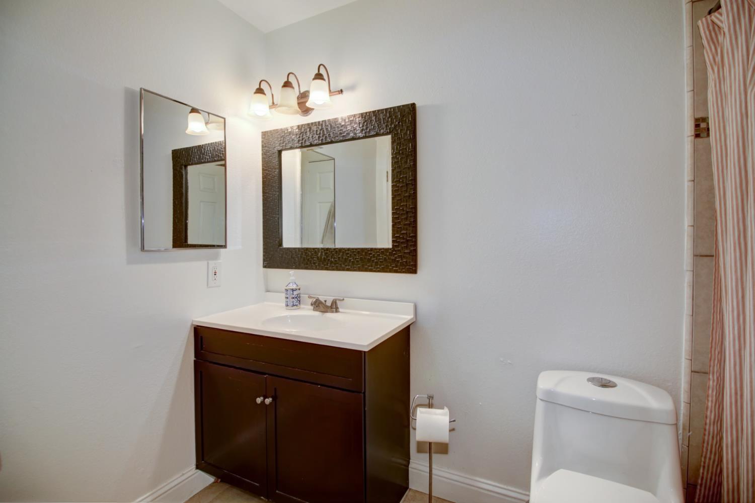 6114 Shadow Lane Citrus Heights, CA 95621 - Photo 7 of 56 a bathroom with a toilet sink and mirror