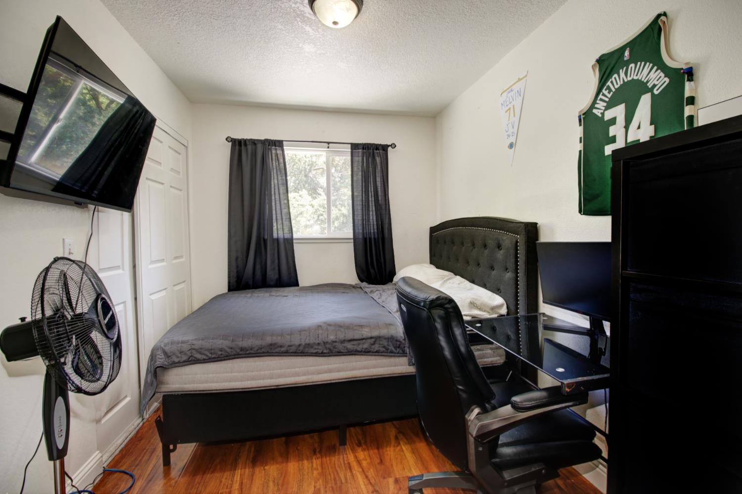 6114 Shadow Lane Citrus Heights, CA 95621 - Photo 9 of 56 a bedroom with a bed a flat tv screen and a dresser