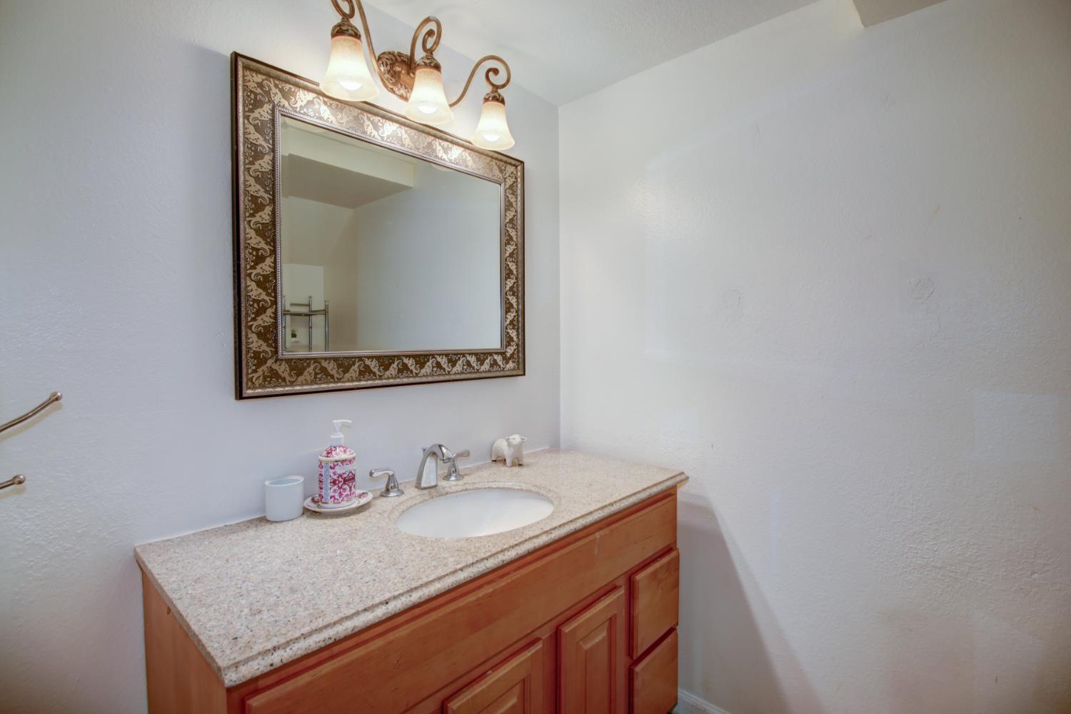 6114 Shadow Lane Citrus Heights, CA 95621 - Photo 10 of 56 a bathroom with a granite countertop sink and a mirror