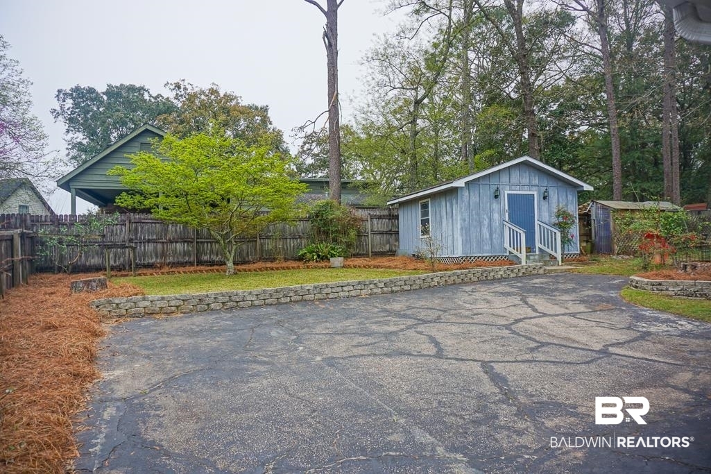 7225 Smithfield Road East Mobile, AL 36695 - Photo 25 of 27 Exterior space featuring aphalt driveway and a fenced backyard