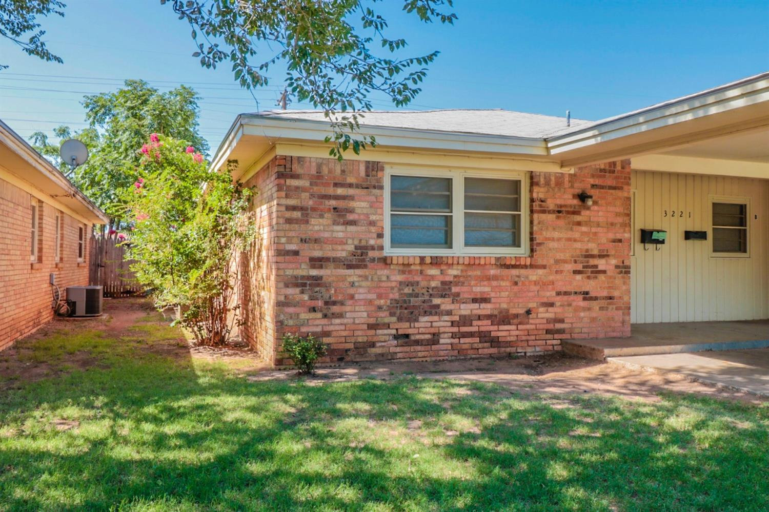 a front view of house with a garden