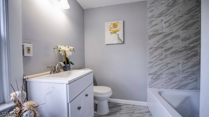 11 Hendrickson Road Lawrence Township, NJ 08648 - Photo 17 of 24 a bathroom with a sink mirror vanity and toilet