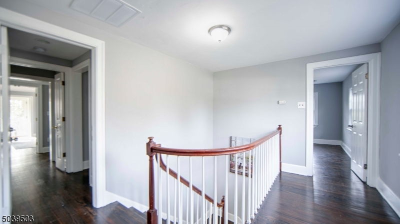 11 Hendrickson Road Lawrence Township, NJ 08648 - Photo 18 of 24 a view of a hallway with wooden floor and stairs