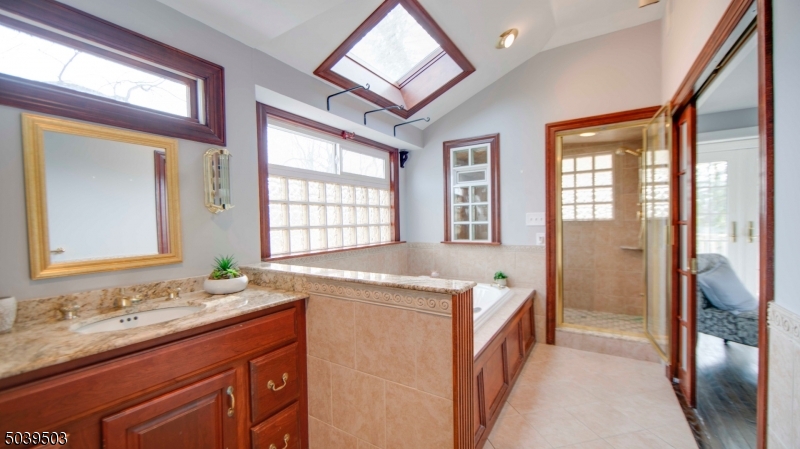 11 Hendrickson Road Lawrence Township, NJ 08648 - Photo 19 of 24 a bathroom with a double vanity sink and a mirror