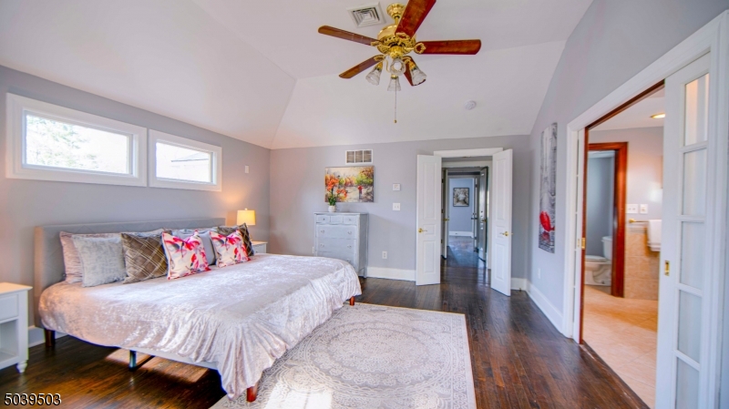 11 Hendrickson Road Lawrence Township, NJ 08648 - Photo 23 of 24 a bedroom with a bed and a chandelier