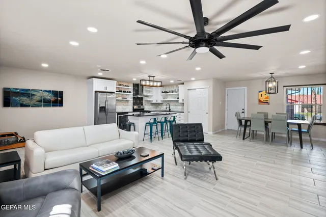 a living room with furniture and kitchen view