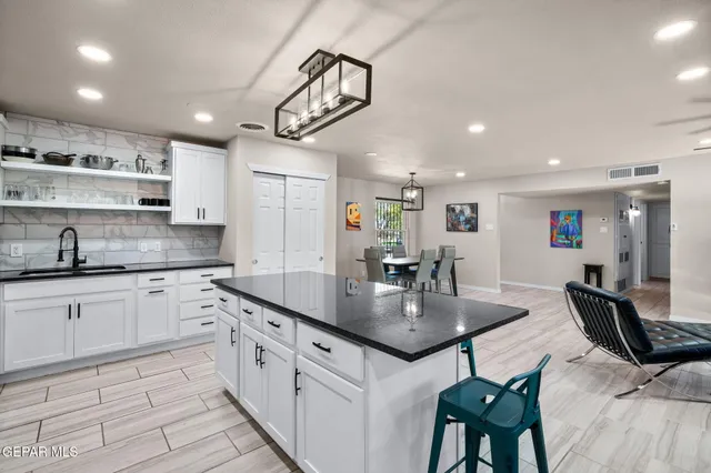 a kitchen with stainless steel appliances granite countertop a sink counter space and cabinets