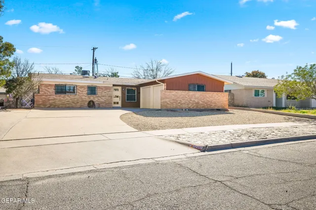 a spacious bathroom with a granite countertop sink and a mirror