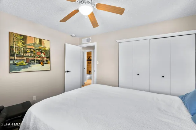 a bedroom with a bed and a painting on the wall