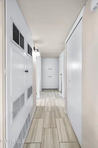 a view of a hallway with wooden floor