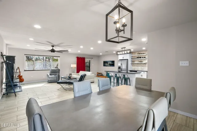 a living room with lots of furniture and kitchen view