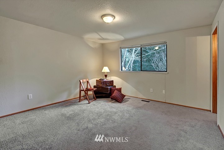 2905 165th Place Southeast Bothell, WA 98012 - Photo 10 of 18 an empty room with windows and couch