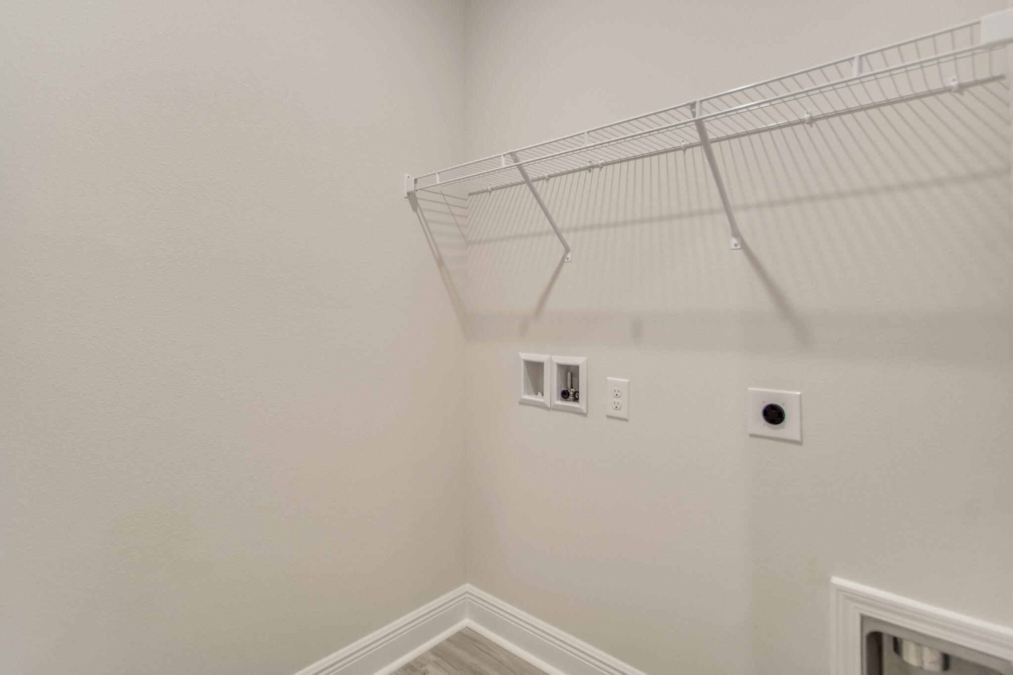 8676 Bluebell Street Milton, FL 32583 - Photo 21 of 32 a view of a room with racks on the wall