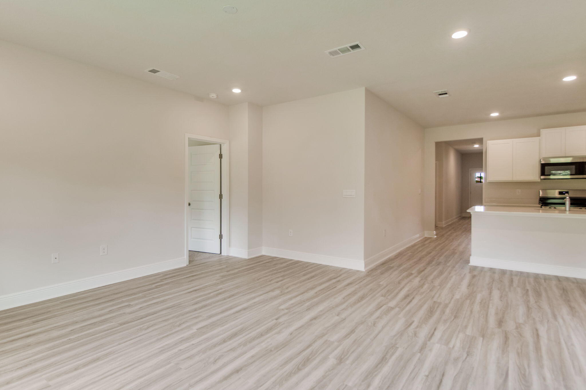8676 Bluebell Street Milton, FL 32583 - Photo 7 of 32 a view of a kitchen with wooden floor and a sink