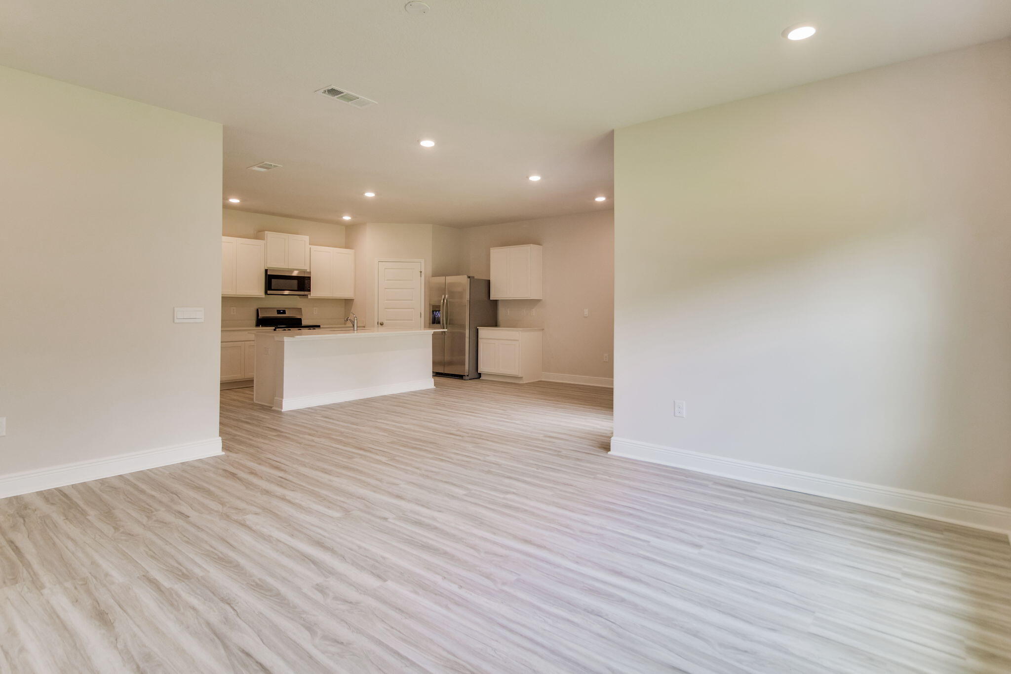 8676 Bluebell Street Milton, FL 32583 - Photo 8 of 32 a view of a kitchen with a sink and a refrigerator